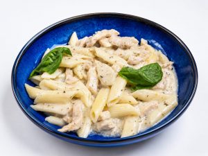 Bowl of orzo soup with a spoon