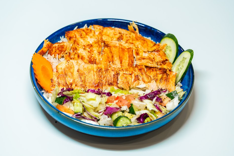 Shawarma Rice شاورما مع الرز Chicken shawarma slices with white rice served with Arabic salad, vegetables and